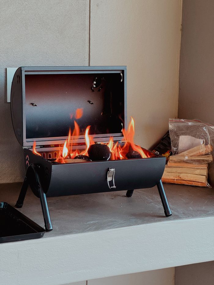 Crafting Captivating Headlines: Your awesome post title goes here Small portable barbecue grill with glowing flames indoors, ideal for cozy gatherings.